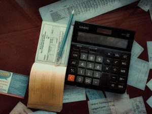 Calculator and receipts on a desk, illustrating fund accounting records