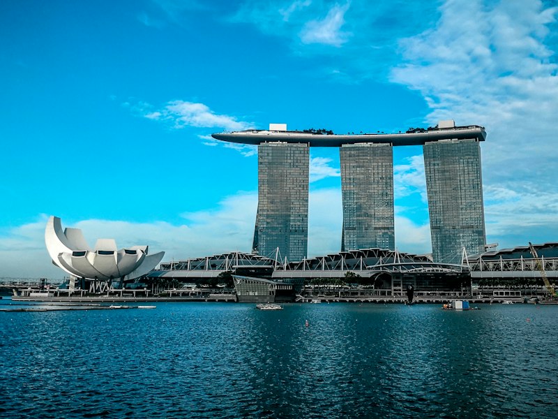 Marina Bay Sands and the ArtScience Museum on the Singapore waterfront by day under a blue sky