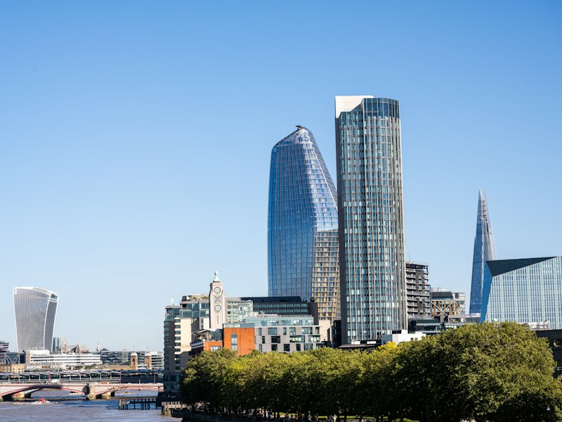 London South Bank skyline under a clear blue sky, with the Oxo Tower, One Blackfriars, The Shard and 20 Fenchurch Street beside the River Thames